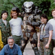 Stan Winston and his crew on the set of Predator. Left to right: Shane Mahan, Steve Wang, Stan Winston (crouching), Brian Simpson, Kevin Peter Hall (as Predator), Shannon Shea, Richard Landon, and Matt Rose.